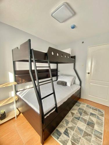a bedroom with two bunk beds with a ladder at MQ Staycation at One Oasis in Cagayan de Oro