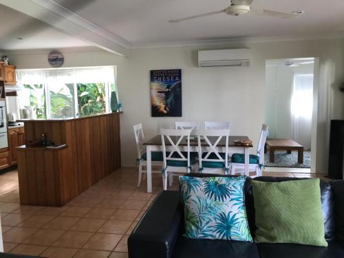 a living room with a couch and a table at Mudjimba Esplanade Villa in Mudjimba