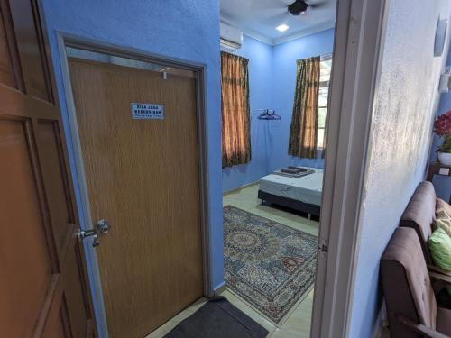 a door leading into a room with a bedroom at Mufeed Homestay in Kampong Wakaf Tengah