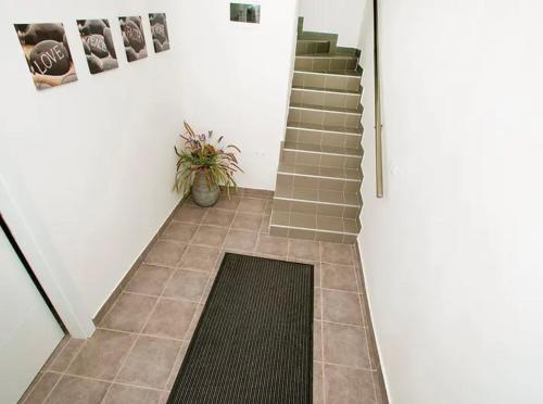 a staircase with a tile floor and a stair mat at DreamWorksApartments in Karlobag
