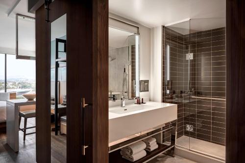 a bathroom with a large sink and a shower at Marriott Irvine Spectrum in Irvine