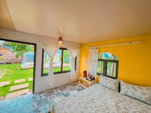 a bedroom with a bed and a large window at Lacasa home&coffee Mộc Châu in Mộc Châu