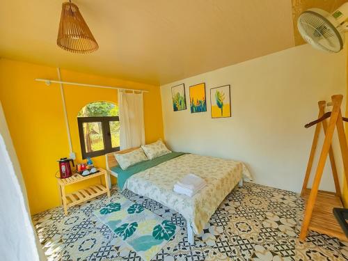 a small bedroom with a bed and a window at Lacasa home&coffee Mộc Châu in Mộc Châu