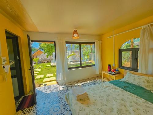 a bedroom with a bed and a window at Lacasa home&coffee Mộc Châu in Mộc Châu