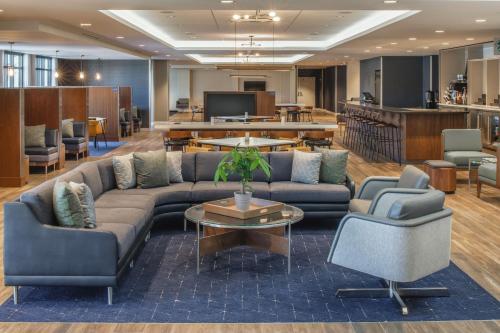 a lobby with a couch and two chairs and a table at Courtyard by Marriott Santa Cruz in Santa Cruz