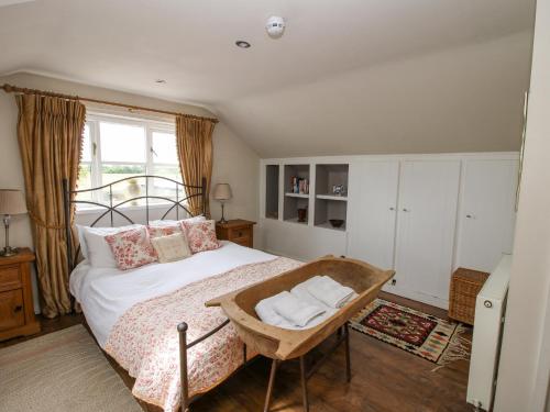 a bedroom with a large bed and a window at The Barn in Preesgreen