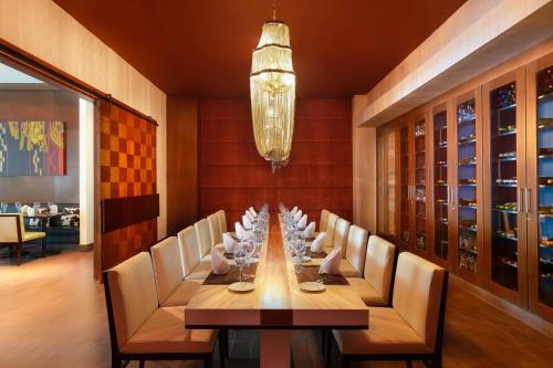 a dining room with a long table with chairs and a chandelier at The Westin Playa Bonita Panama in Playa Bonita Village