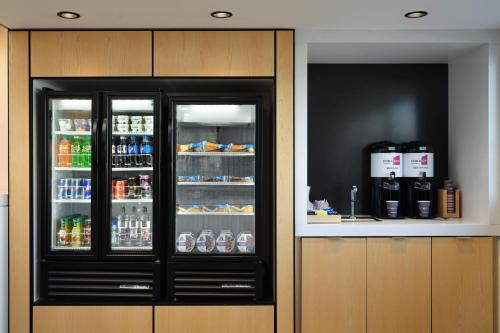 a refrigerator with its doors open with drinks in it at Aloft Knoxville West in Knoxville