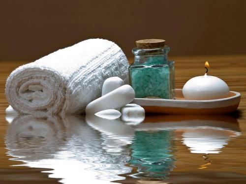 a towel and a candle and a bottle of soap at Breaffy House Hotel and Spa in Castlebar
