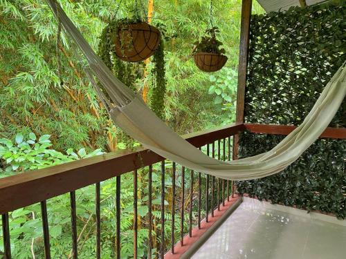 a hammock on a balcony with a fence at Hotel La Casablanca Tayrona in Calabazo