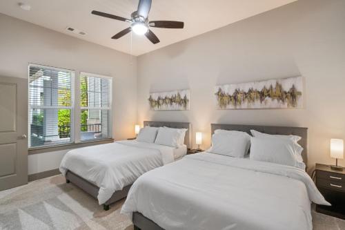 a bedroom with two beds and a ceiling fan at Grand Luxury Premium Vaulted Ceilings in Woodbridge
