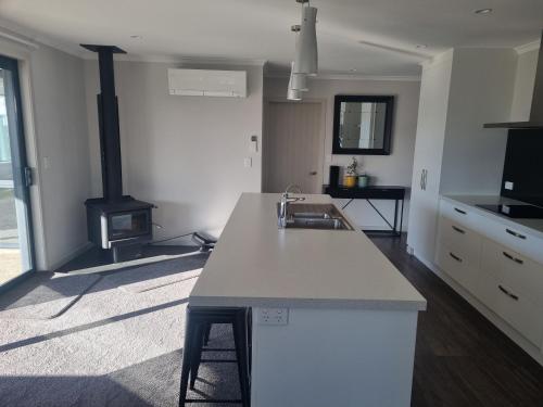 a kitchen with a counter top and a stove at Jafa's Holiday House in Lawrence