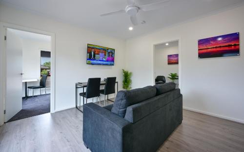 a living room with a couch and a table at Comfort Inn & Suites Augusta Westside in Port Augusta