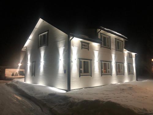 a building with lights on the side of it at night at Villa Kipakka in Kihniö