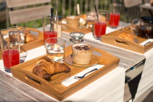 a table with a tray of bread and a cup of coffee at La Corte sul Naviglio in Boffalora sopra Ticino