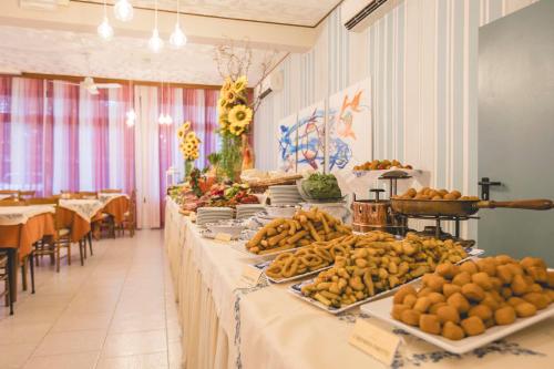 a buffet line of tables with fruit on them at Hotel Stella Del Mare in Cervia