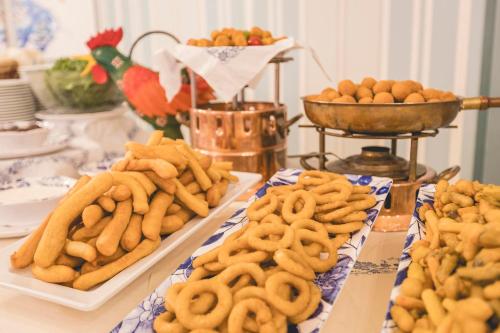 a table topped with plates of cookies and other foods at Hotel Stella Del Mare in Cervia