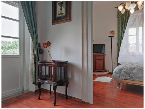 a bedroom with a bed and a table in a room at Villa Royal in Cetinje