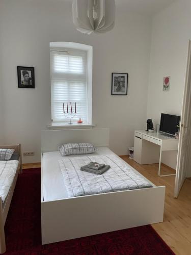 a white bedroom with a bed and a window at Villa Reder in Bad Sauerbrunn