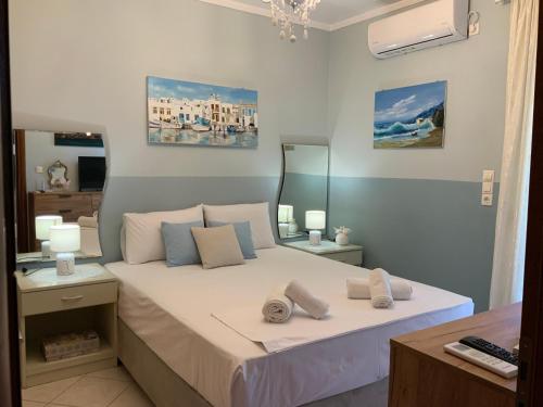 a bedroom with a large bed with a mirror at Γαλήνη in Salamina