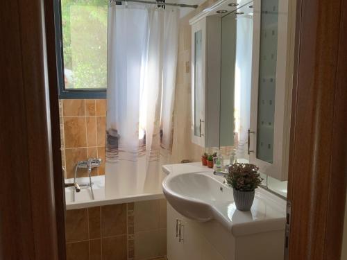 a bathroom with a sink and a shower and a tub at Γαλήνη in Salamina