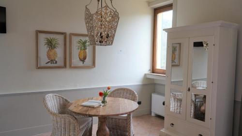 a dining room with a table and chairs and a chandelier at La Torre wine resort in Montecarlo