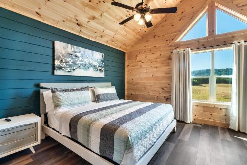 a bedroom with a bed and a ceiling fan at The Heritage in Pigeon Forge