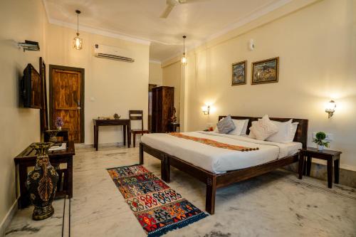 a bedroom with a large bed in a room at Tripli Hotels Shiv Villas in Udaipur