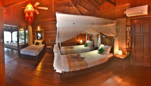 an aerial view of a bedroom with two beds at Nunukan Island Resort in Maratua Atoll