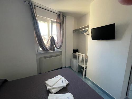 a small room with a bed and a window at Nereide in Tropea