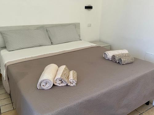 Una cama con toallas encima. en Intro e idda casa vacanza, en Nulvi
