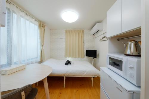 a small kitchen with a table in a room at Nakano Five by Tranova in Tokyo