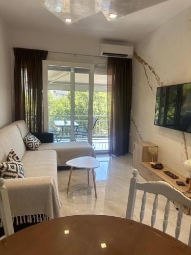 a living room with a couch and a table at Greek Escape in Paleo Tsifliki
