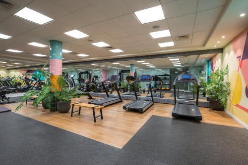 a gym with a lot of plants and machines at Royal Garden by Isrotel Collection in Eilat