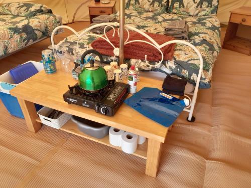 a coffee table with a tea kettle on top of it at Cornish Skies Glamping in Pool