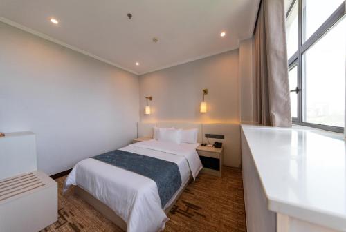 a hotel room with a bed and a window at Legend Hotel and Resort in Sihanoukville