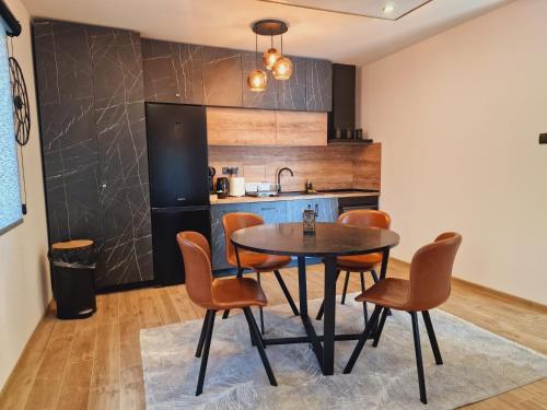 a kitchen and dining room with a table and chairs at Relax House NS in Novi Sad