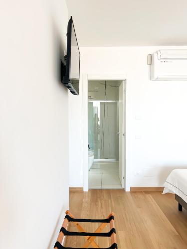 a white room with a bed and a bathroom at Glass House - Smart Rooms & Parking in Lecce