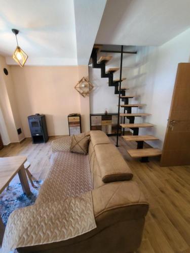 een woonkamer met een bank en een trap bij Villa Kristina - Apartment no.1 in Vrben