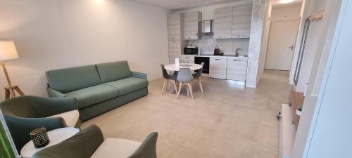 a living room with a couch and a table at Relax-Lugano Lake in Bissone