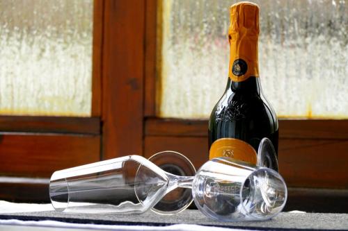 a pair of glasses sitting next to a bottle of wine at Villa Sorgenfrei in Reutte