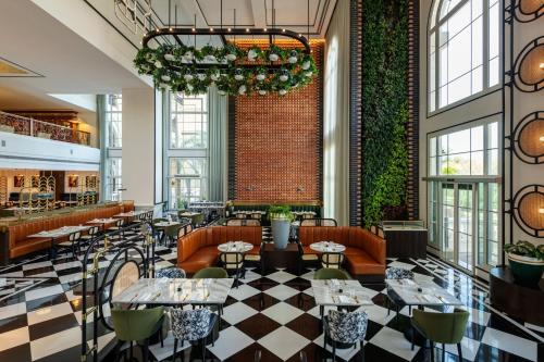 a restaurant with a checkered floor and tables and chairs at The Westin Dubai Mina Seyahi Beach Resort and Waterpark in Dubai