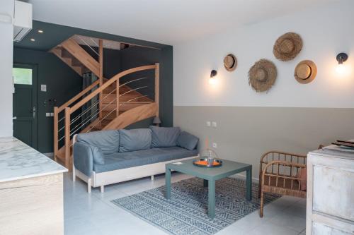 a living room with a blue couch and a table at H de Surgères in Surgères