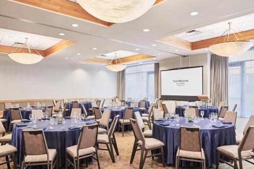a conference room with tables and chairs and a screen at The Westin Bayshore, Vancouver in Vancouver