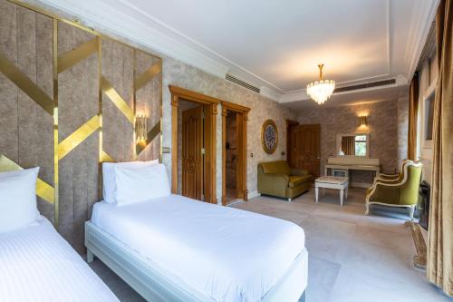 a bedroom with two beds and a living room at Wyndham Istanbul Old City in Istanbul