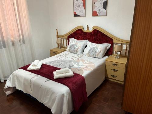a bedroom with a bed with two towels on it at Casa da Isilda ,three bedrooms in Estreito da Calheta