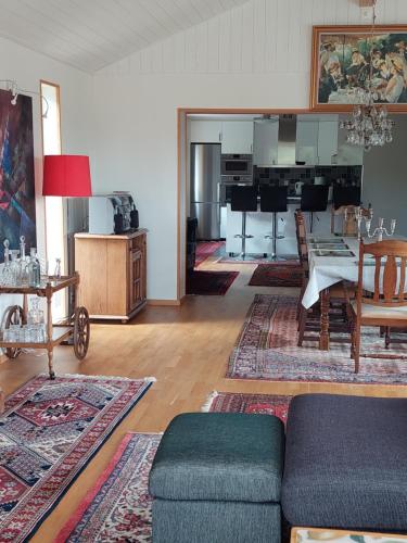 a living room with a couch and a table at Villa med sjöutsikt in Immeln