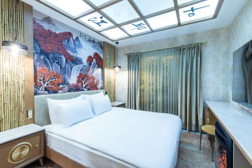 a bedroom with a white bed and a painting on the wall at Wyndham Istanbul Old City in Istanbul