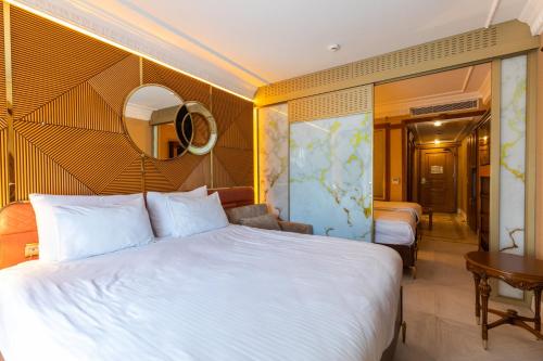 a hotel room with a large bed and a mirror at Wyndham Istanbul Old City in Istanbul