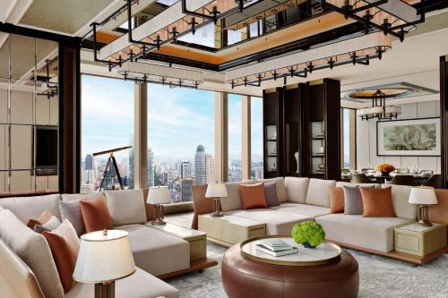 a living room with couches and a view of the city at The Ritz-Carlton, Nanjing in Nanjing